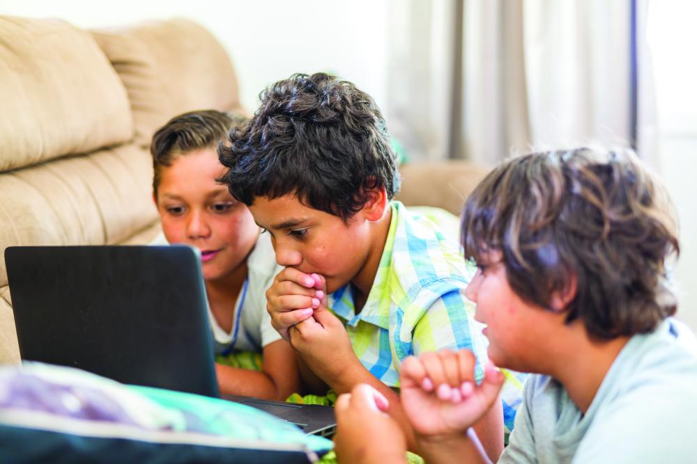 Young boys looking at something on a computer