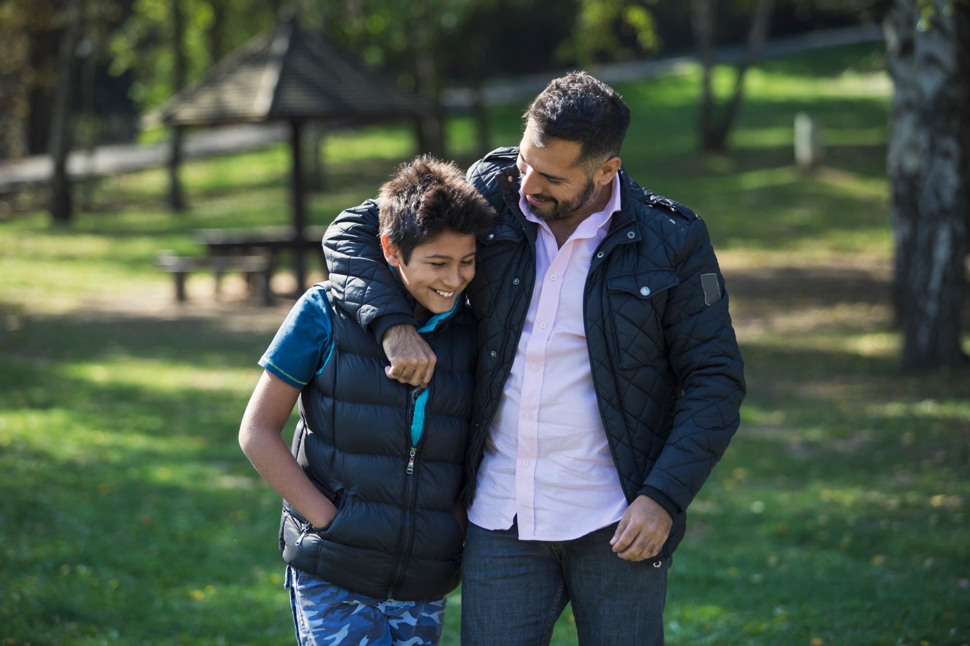 man hugging teen